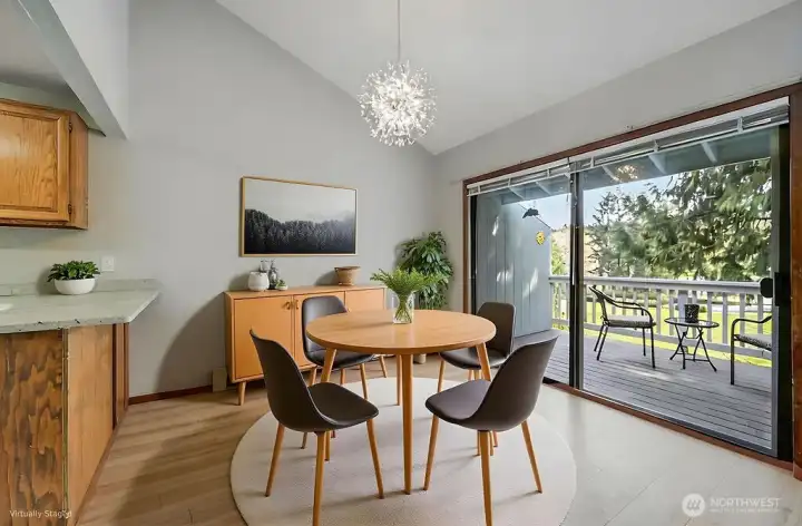 The furnishings in this photo are AI, but the fabulous chandelier and views are very real! Love the vaulted ceilings and great deck space, too.