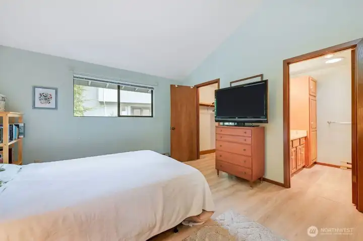 Another angle in the primary bedroom, with a 3/4 bath with new shower, and a walk in closet on the left.