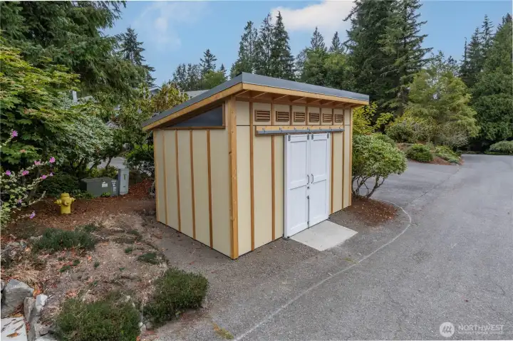 The HOA dues include garbage service, and the HOA keeps the area clean with this new enclosed refuse shed.