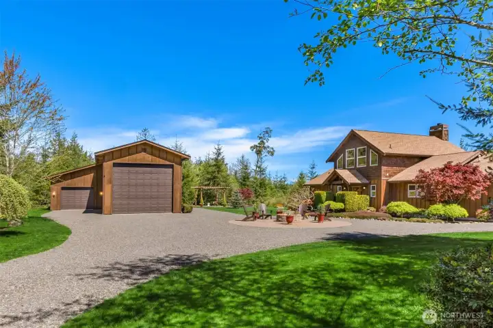 The pole barn’s oversized door provides storage for a large boats or RVs with room to spare, and the adjacent parking space (on the right side of the barn here) also offers access to the building’s power and water. The smaller door is currently set-up as a shop, but could be additional parking, storage, or just sheltered hangout space separate from the main house.