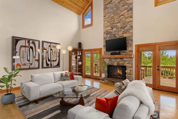 Two sets of French doors lead from the living room to the spacious covered portion of the view-oriented deck.