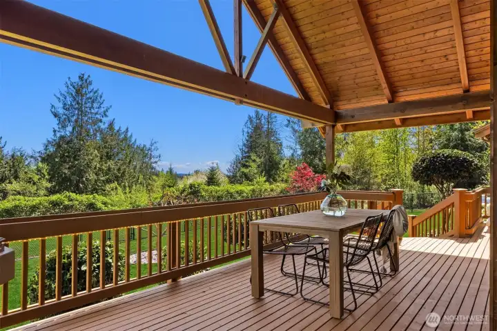 The spacious covered portion of the deck is equally comfortable for a quiet evening at home or entertaining a large group. There’s ample space for dining, lounging, and grilling! Two sets of stairs lead to fenced back yard.