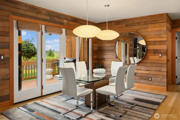 The dining space is clearly defined, yet nicely connected to the kitchen and living room. Once again, a set of French doors open to the deck - a perfect spot for grilling in the balmy months!