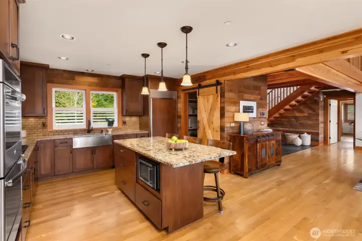The kitchen connects nicely with the entry and living room, with ample space to circulate as well. Now…on to the primary bedroom, seen on the far side of the home from this vantage.