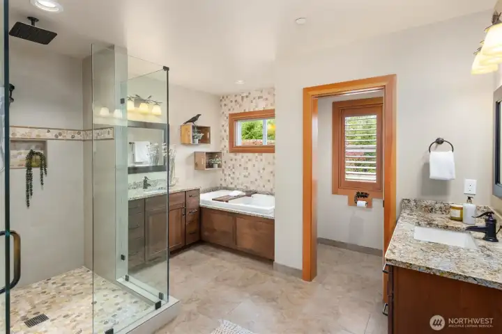 The primary bath’s 2 vanities are separate, and each includes plenty of counter space and drawers. The deep soaking tub is a dream, and the shower stall is just the right size - not too tight, but enclosed enough to stay warm and steamy.