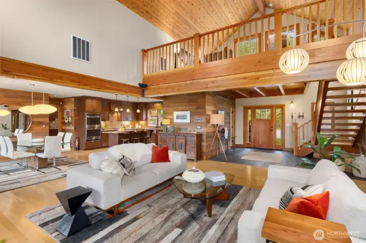 Here, we see the connection between the various functional areas of the home, with the entry giving way to the great room and open space for easy circulation to the rest of the home. The kitchen and dining room are more intimate with their lower ceilings. Perfection! You will also find a powder room off the entry (left of the door here), and the utility room and attached garage through the door to the right of the dining room.