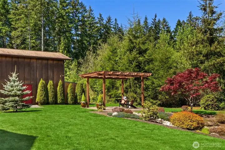 The garden pergola is a lovely place to enjoy afternoon sun and admire the colorful, easy-care landscaping.