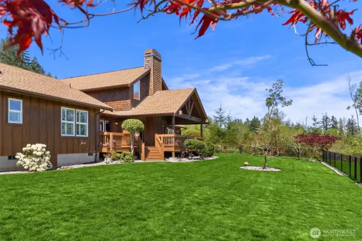 The fenced back yard is ideal to contain pets or children, and is accessible through gates as well as two sets of stairs off the deck.