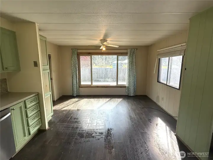 Dining room with large windows surrounding. Door to the left takes you outside.