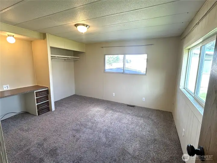 Primary bedroom with built in desk.