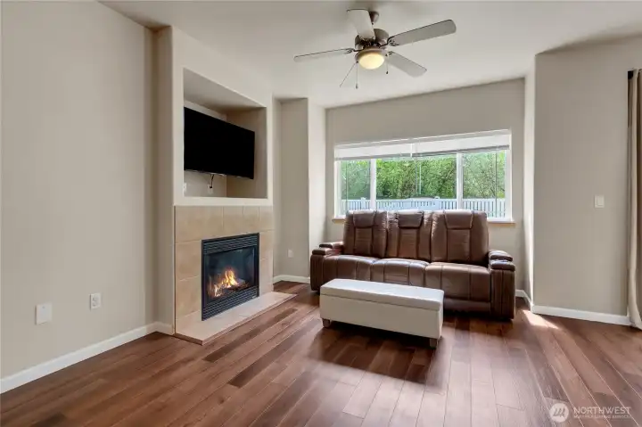 Comfortable living room located just off the kitchen and dining area, featuring a cozy gas fireplace perfect for relaxing or entertaining.