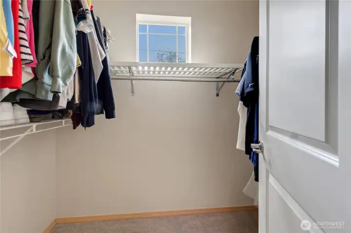 Primary suite walk-in closet providing ample storage and convenient organization space.