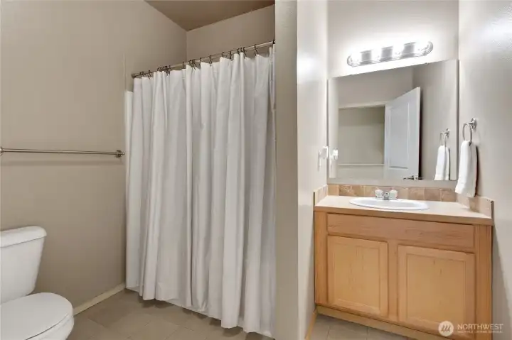 Upstairs full bathroom featuring a tub/shower combination, designed for everyday convenience and shared use.