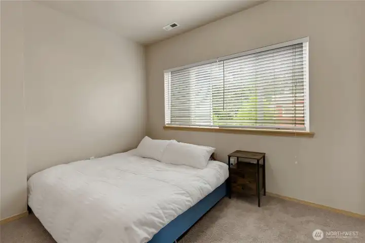 Additional bedroom featuring a walk-in closet, offering comfortable space and practical storage.