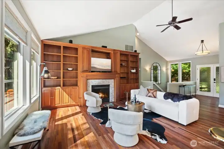 Spacious family room featuring custom built-ins and a cozy gas fireplace.