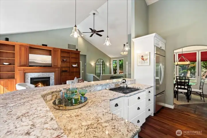 Bright kitchen with quartz countertops, white cabinetry, and abundant workspace.