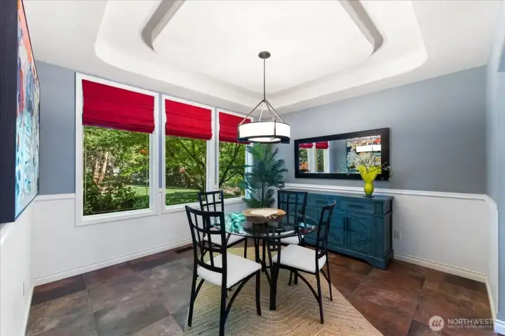 Open dining room conveniently located just off the kitchen for effortless entertaining. Cove ceiling and chair railing give this room an elegant feel.