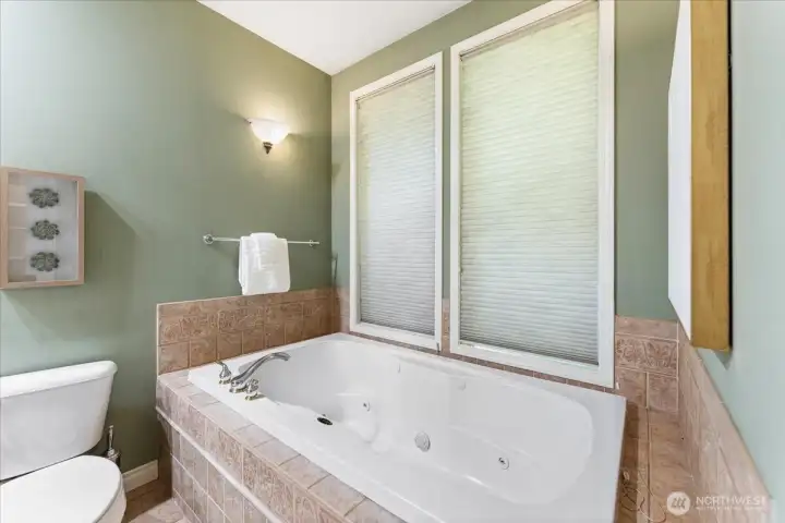 The primary bathroom offers a relaxing retreat with your own soothing jacuzzi tub.