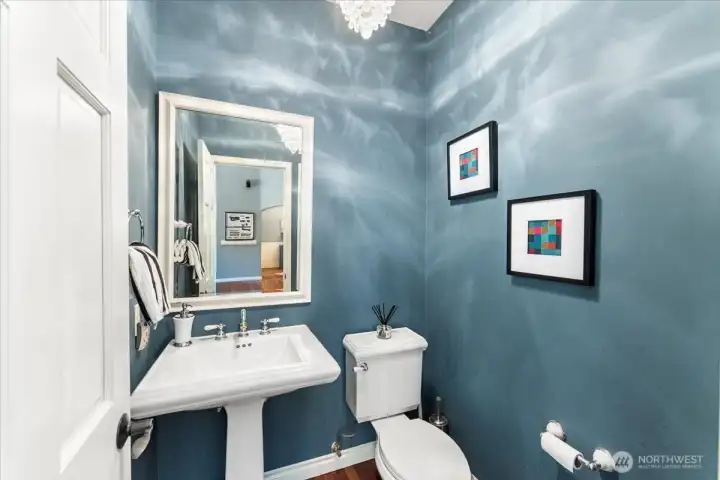 Beautiful guest bath on the main level with a stunning chandelier.