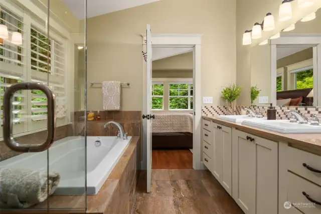 Primary bathroom enjoys Travertine tile through-out and spa tub for relaxation.