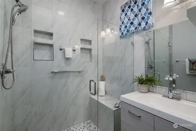 Gorgeous walk in tile shower and vanity.