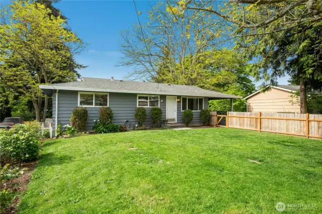 Welcoming front yard is fully fenced.