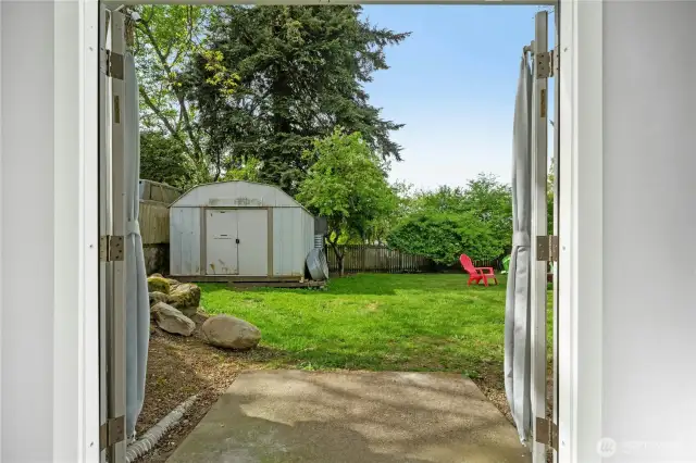Newer French doors open to backyard.
