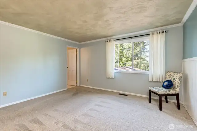 Primary suite with crown moulding, custom textured ceiling, private bath