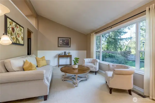 Formal living room has vaulted ceiling
