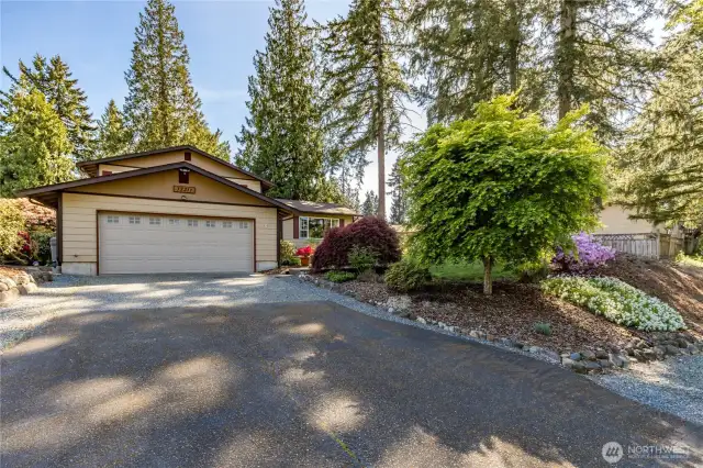 Attached 2-car garage, generous driveway plus a gravel parking area in front of the home