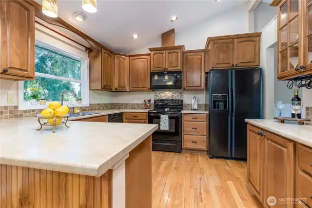 Generous kitchen with rich wood cabinetry