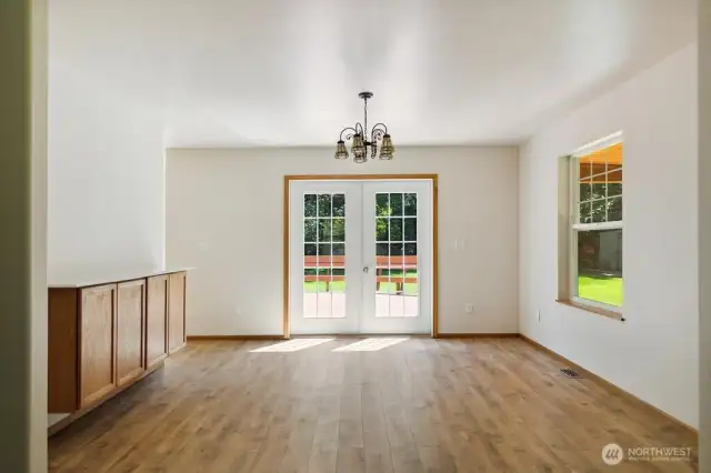 Dining off living room with french doors to deck