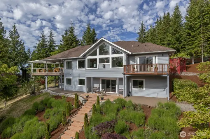 63 Red Cedar is in immaculate condition and offers a covered deck with ceiling heaters, hook-up to a hot tub, a large wine cellar and plenty of room for hobbies and guests,