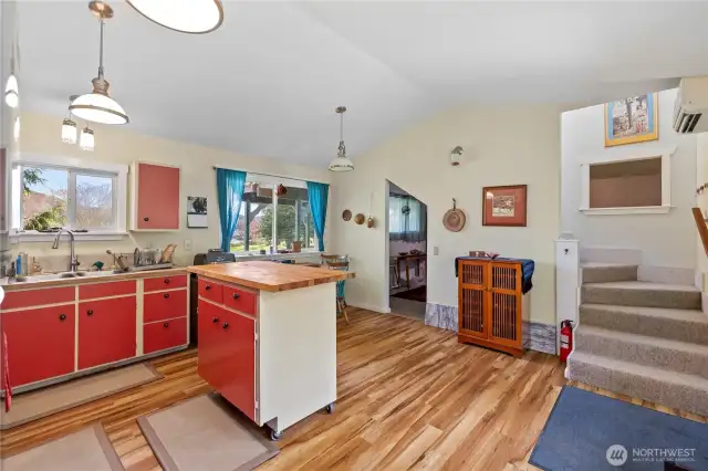 Looking from the kitchen area toward the bedroom through the opening. The stairs lead to the upstairs living space.
