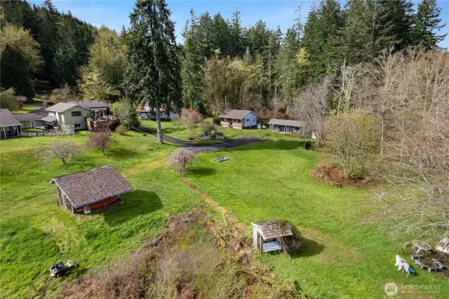 The two cabins are in the center-right in this photo. The building in the front left here is the greenhouse.