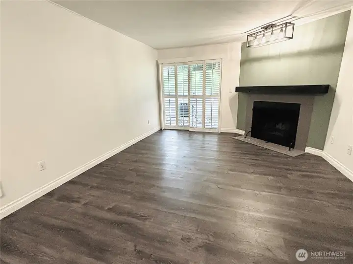 Living room w/slider to the patio. Accent wall with overhead lightling