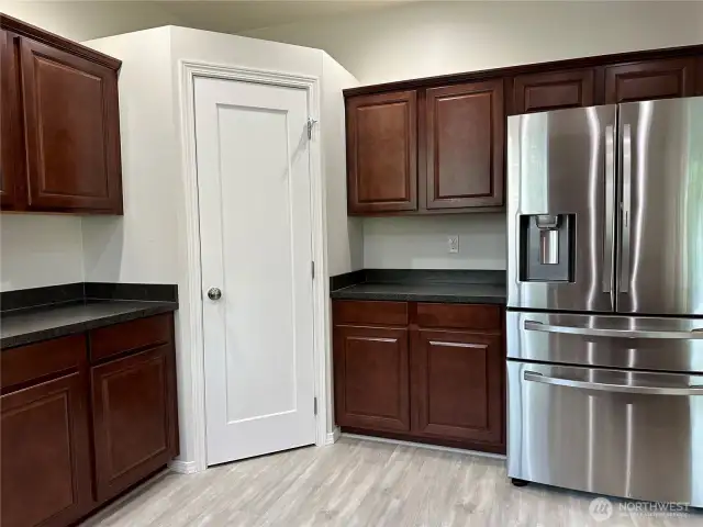 Large fridge + tall cabinets and pantry gives you plenty of kitchen storage, crown molding on cabinets is a nice touch.