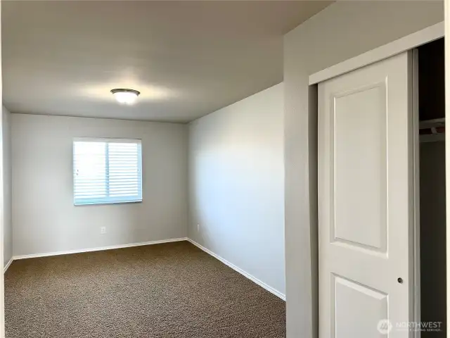 Guest bedroom with double sliding closet doors.