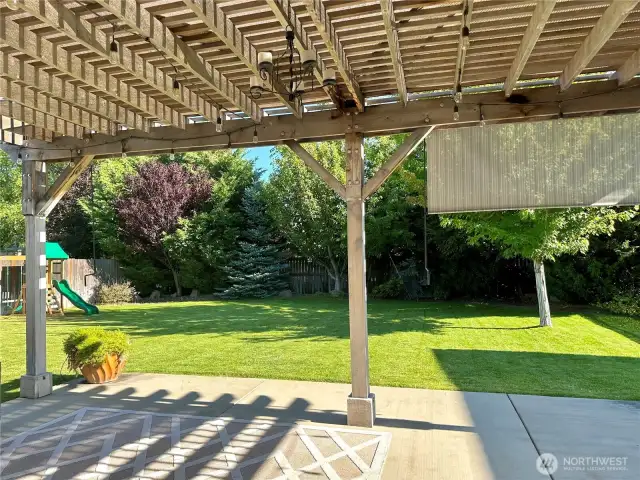 Large patio with a sun cover so you can enjoy this yard year round!