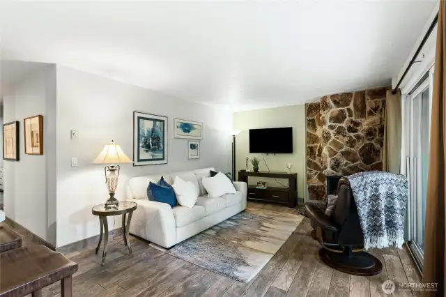 Living room with cozy natural stone fireplace for chilly evenings.