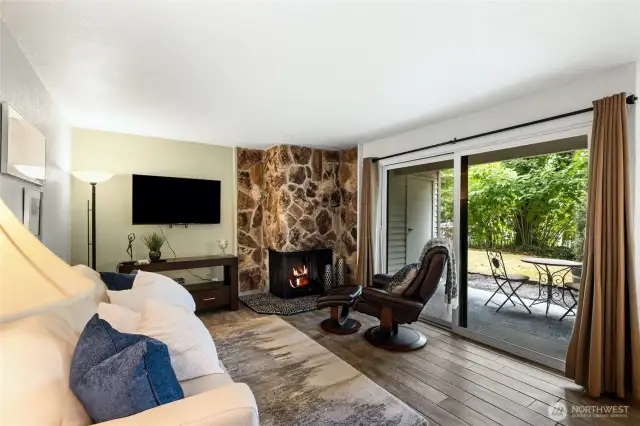 Light-filled living area with serene greenbelt views.