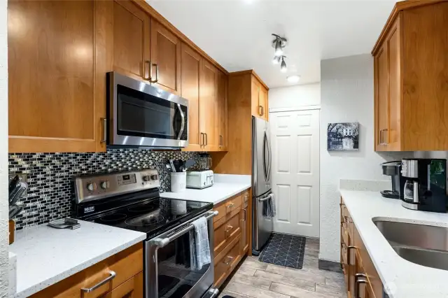 Stunning kitchen with quartz countertops and sleek applilances.