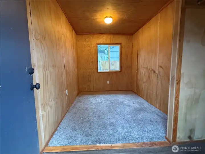 Enclosed storage room off of garage