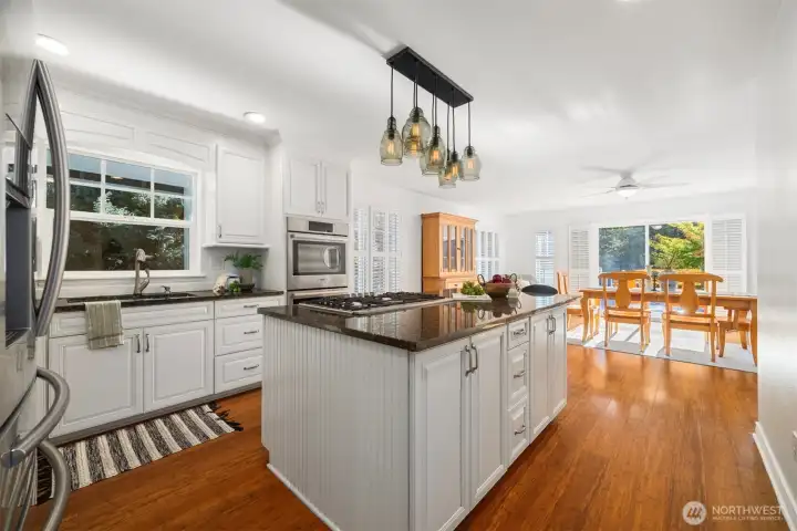 Meals feel special in a room like this—sunlight spills across the table, and trees peek through every window. It’s a space made for connection.