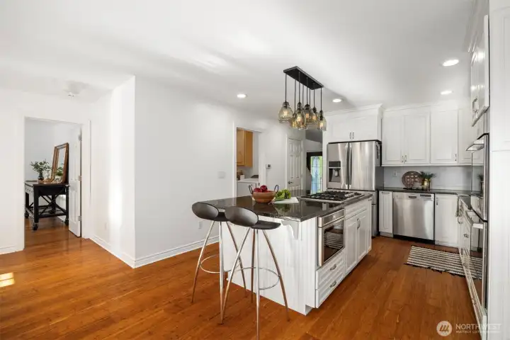 The kitchen & dining room offer bamboo flooring, with the primary suite leading off to the left.