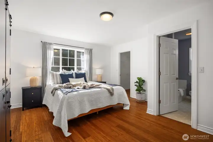 The primary bedroom is on the main floor, and includes a walk-in closet + full bathroom, with stall shower & soaking tub.