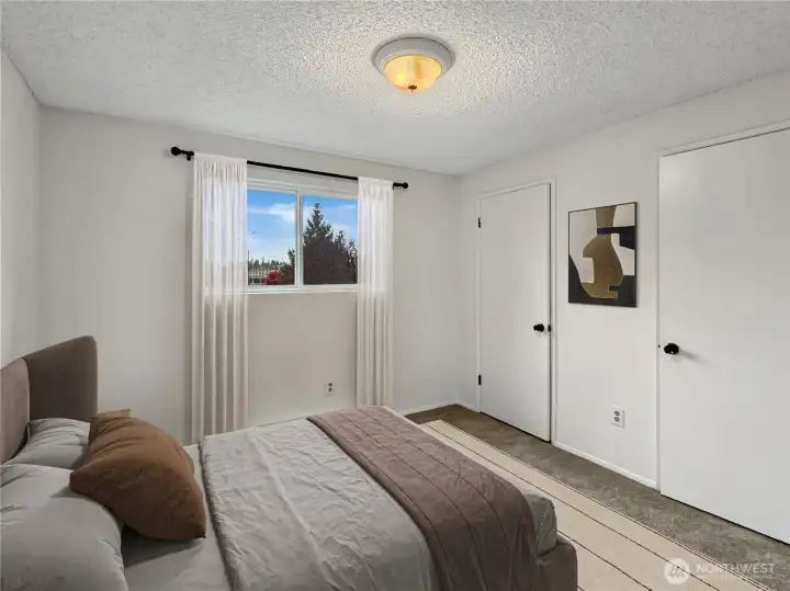 Secondary bedroom with dual closets