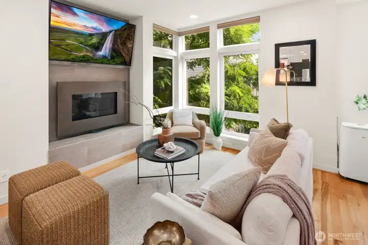 Open concept living/dining/kitchen w/ gas fireplace & floor to ceiling windows