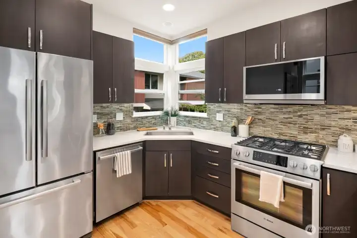 Open concept living/dining/kitchen w/ gas fireplace & floor to ceiling windows