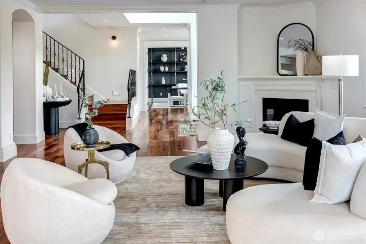 Expansive Great Room features a gas burning fireplace, walls of windows and French Doors leading to a private deck.